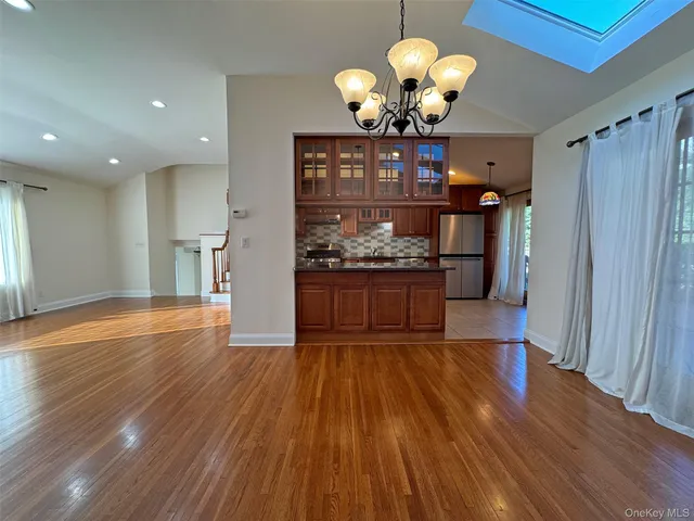 a view of a room with wooden floor