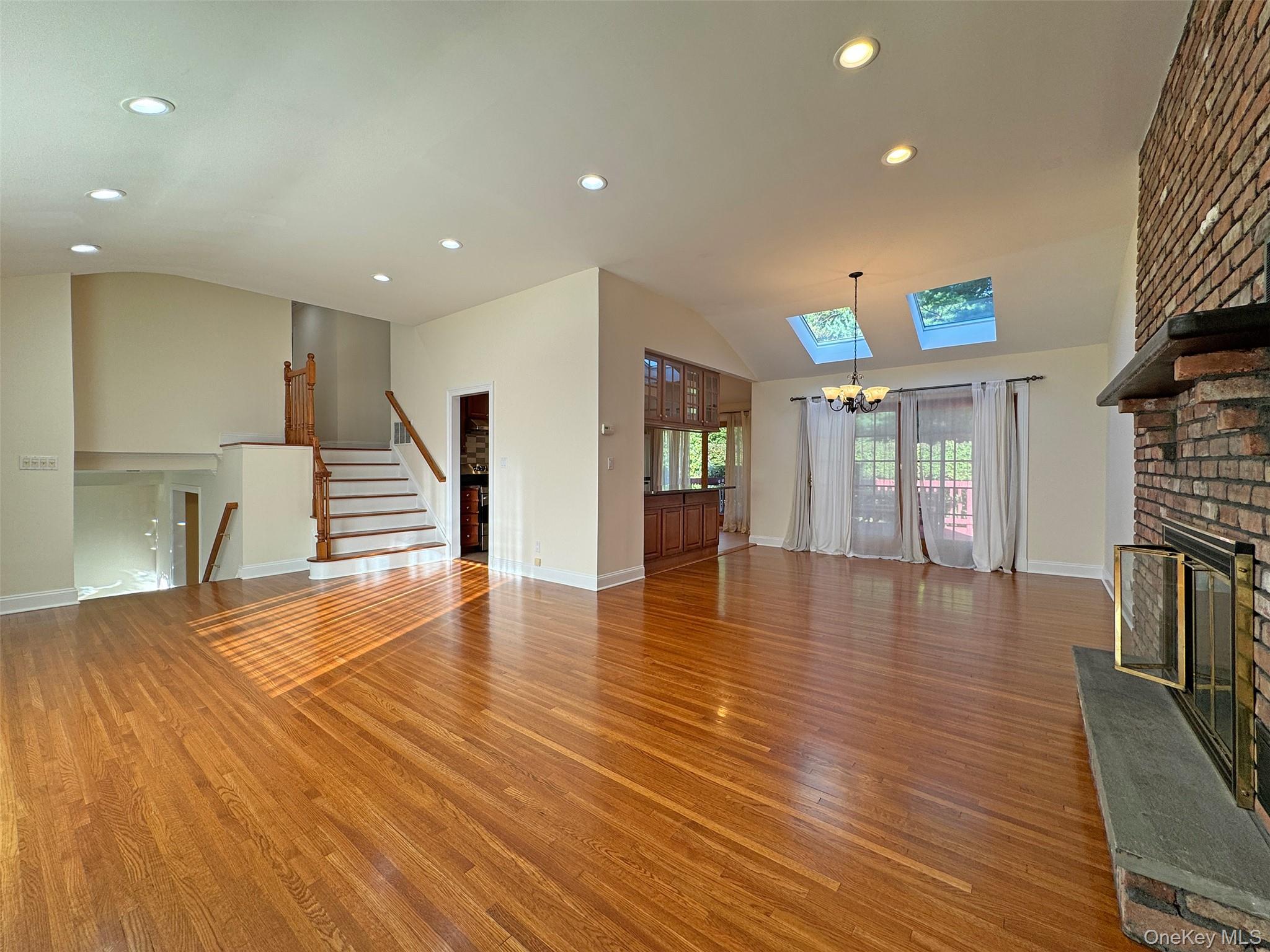 11 Country Ridge Drive Rye Brook, NY 10573 - Photo 7 of 17 a view of an empty room with wooden floor and a fireplace