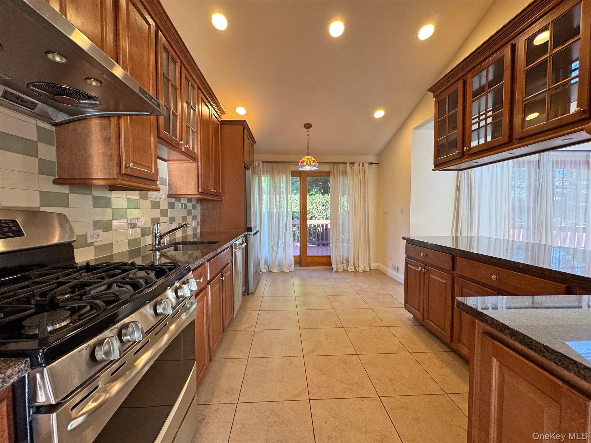 11 Country Ridge Drive Rye Brook, NY 10573 - Photo 9 of 17 a kitchen with stainless steel appliances granite countertop a stove and a sink