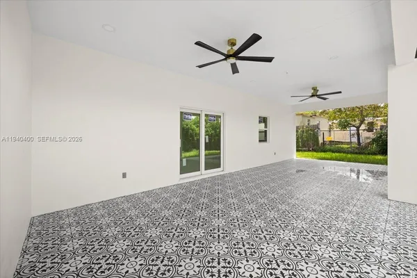 a view of a livingroom with a ceiling fan and window