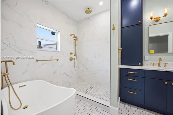 a bathroom with a tub a sink and mirror