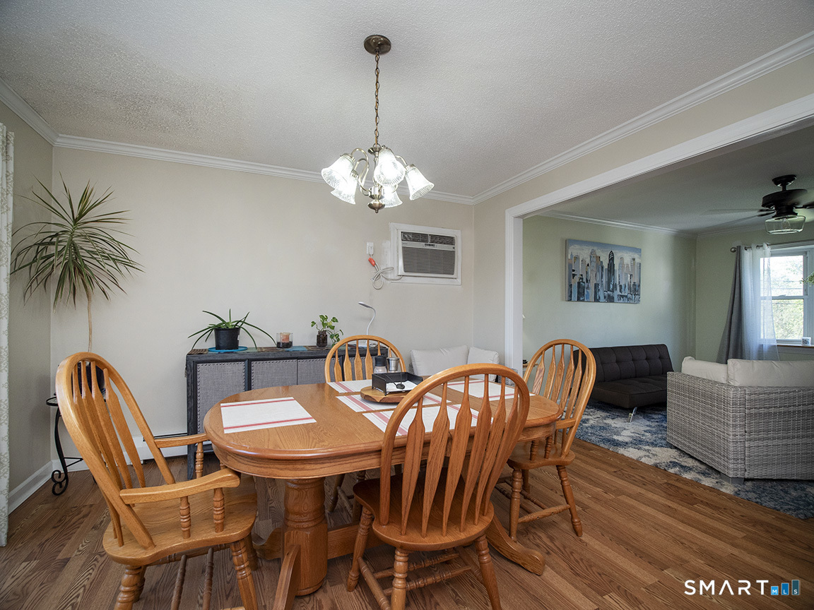 82 Wilcox Road Middletown, CT 06457 - Photo 14 of 27 a view of a dining room with furniture and chandelier