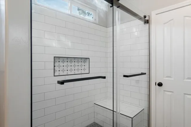 a bathroom with a shower and a shower