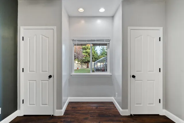 a view of hallway with wooden floor