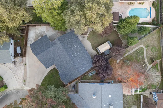 an aerial view of a house with a yard