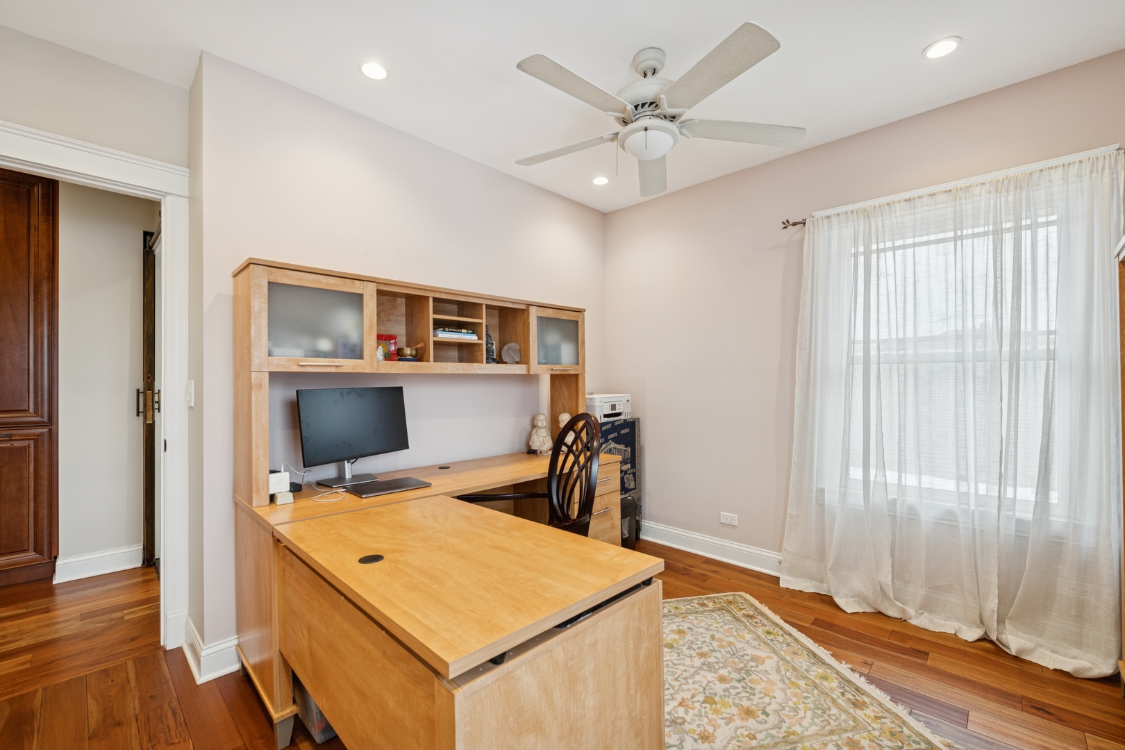 369 Addison Road Riverside, IL 60546 - Photo 13 of 23 a view of workspace with wooden floor and fan