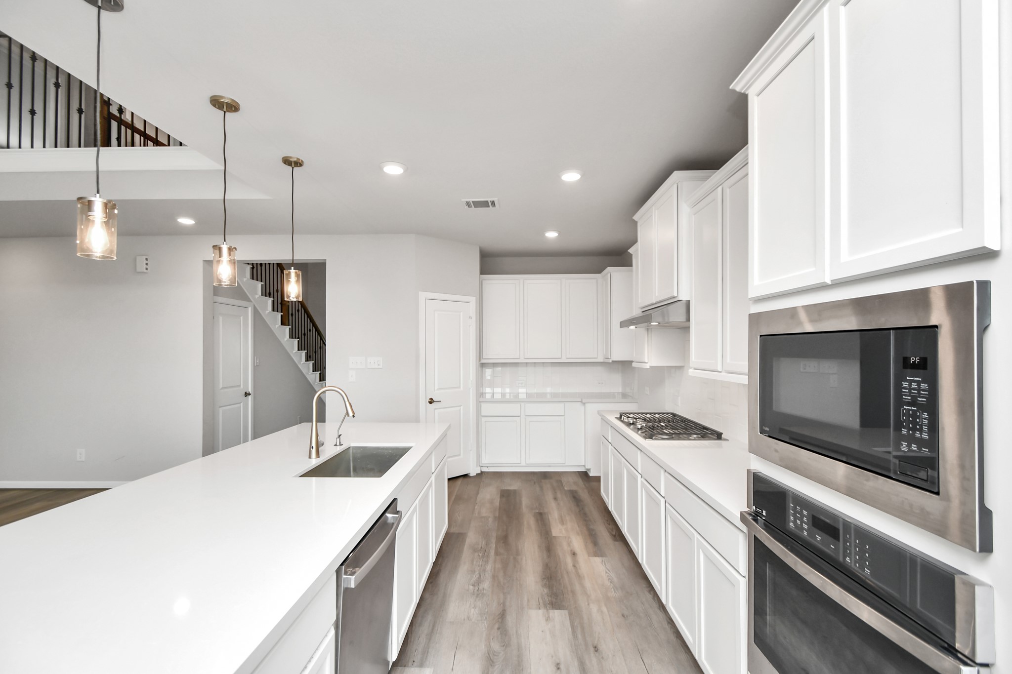 1218 Raburn Run Lane Tomball, TX 77375 - Photo 11 of 37 a kitchen with a sink a counter top space stainless steel appliances and cabinets