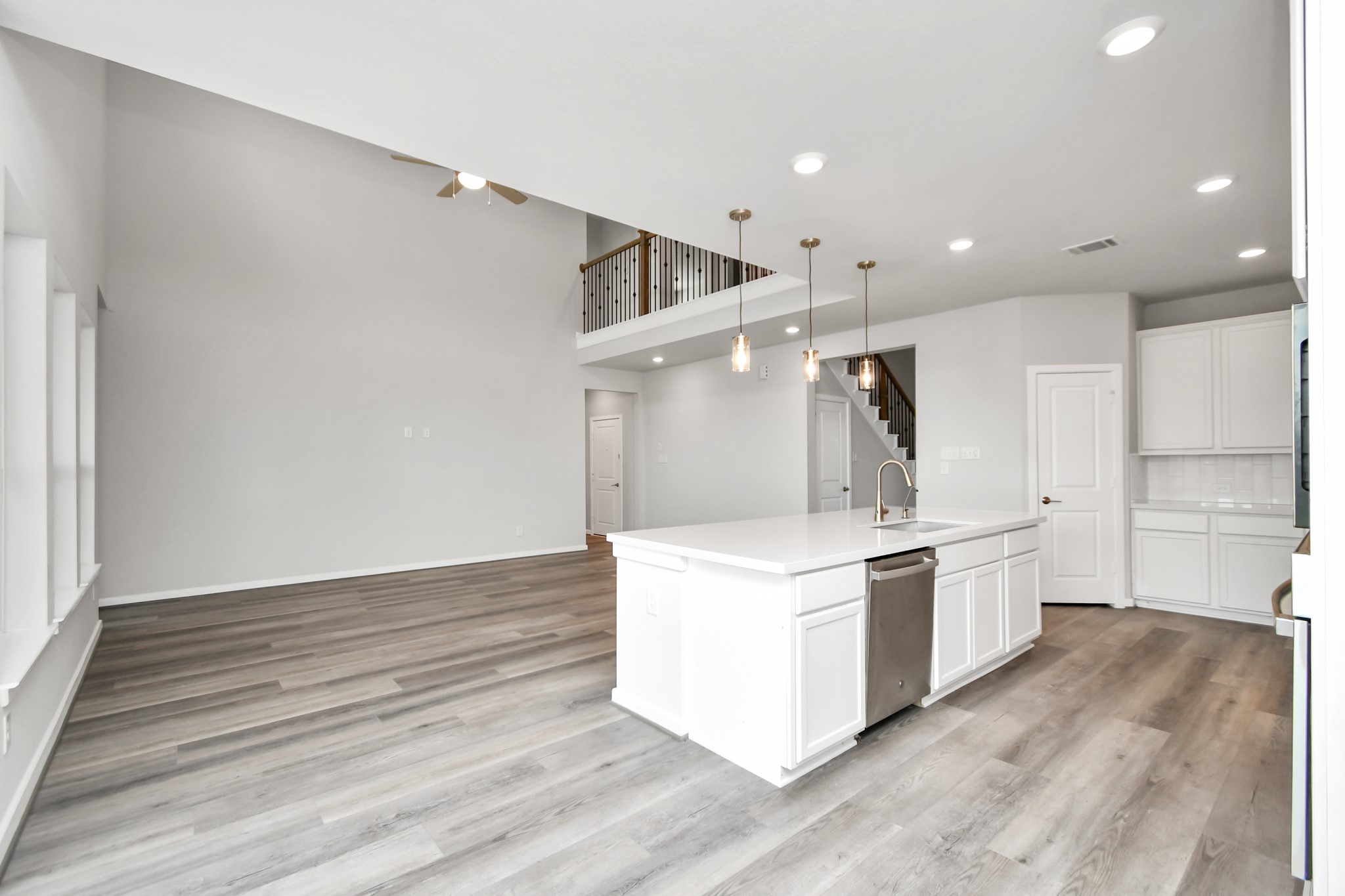 1218 Raburn Run Lane Tomball, TX 77375 - Photo 12 of 37 a kitchen with stainless steel appliances a stove and white cabinets
