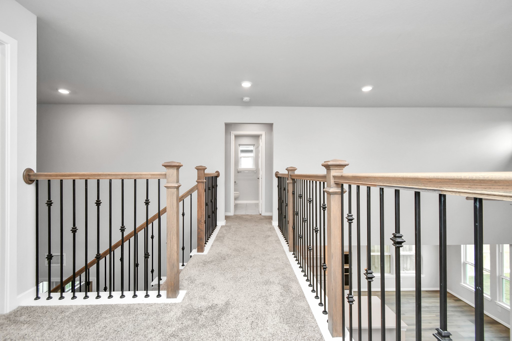 1218 Raburn Run Lane Tomball, TX 77375 - Photo 21 of 37 a view of a hallway with wooden floor