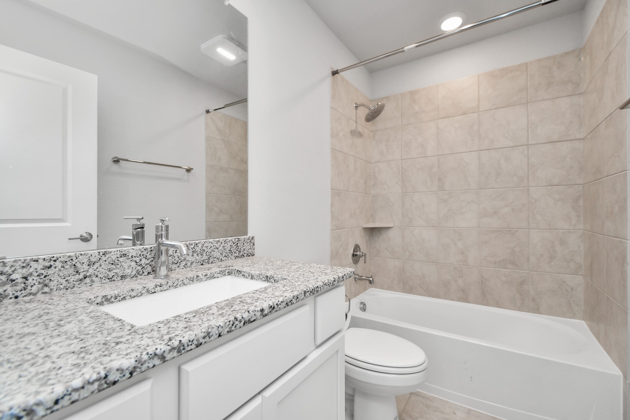 1218 Raburn Run Lane Tomball, TX 77375 - Photo 24 of 37 a bathroom with a granite countertop sink a toilet and shower