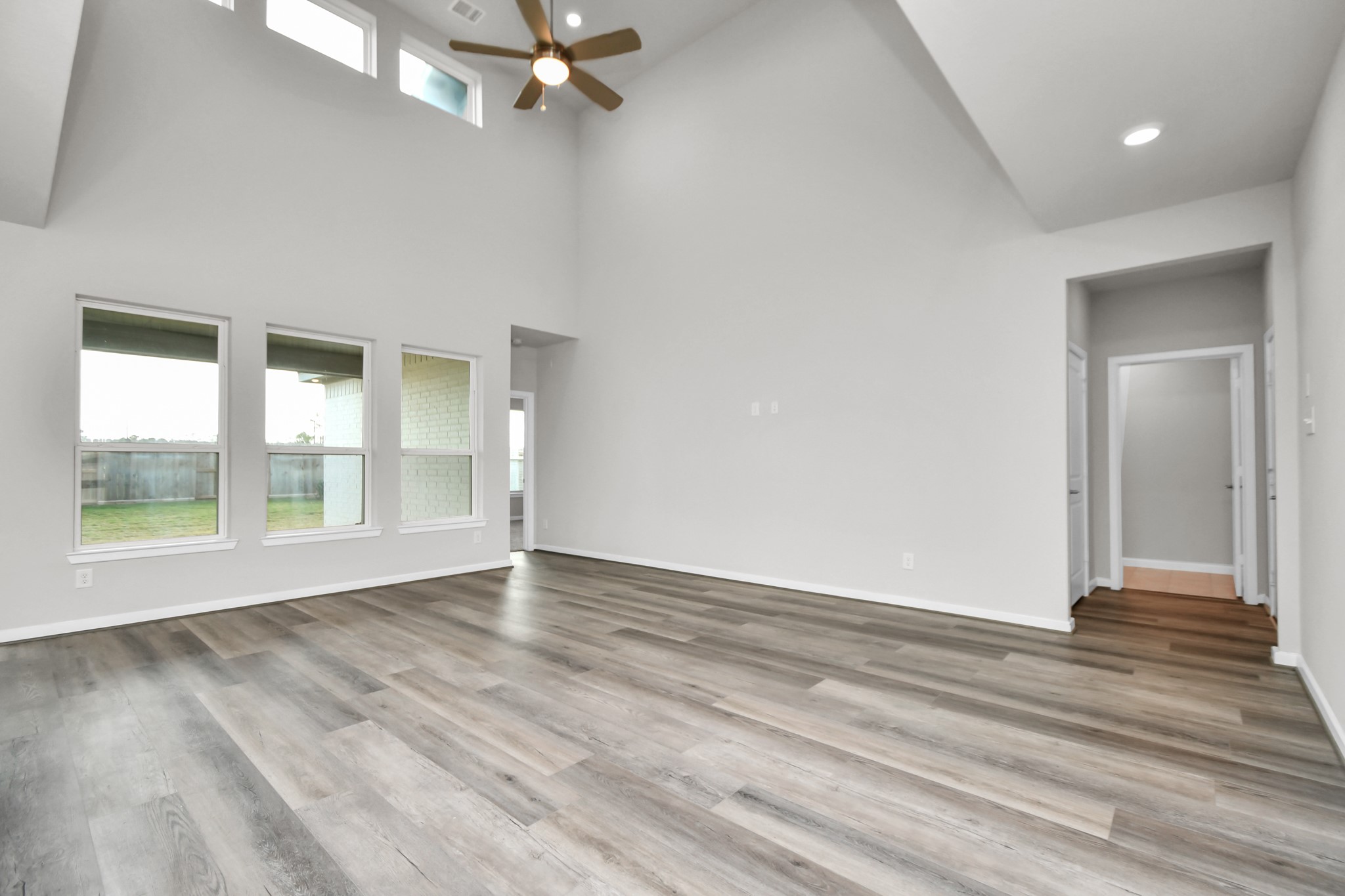 1218 Raburn Run Lane Tomball, TX 77375 - Photo 5 of 37 a view of an empty room with wooden floor and a window
