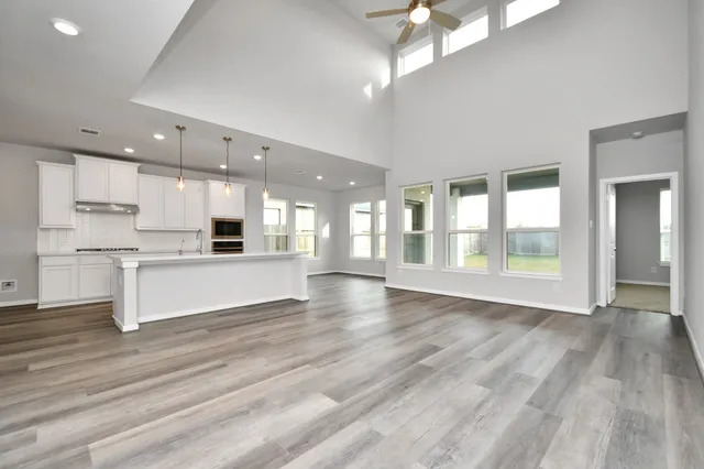 a view of large kitchen with a sink and refrigerator