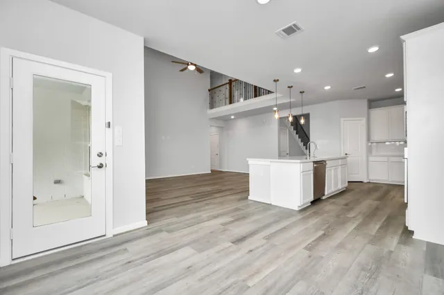 a view of empty room with wooden floor
