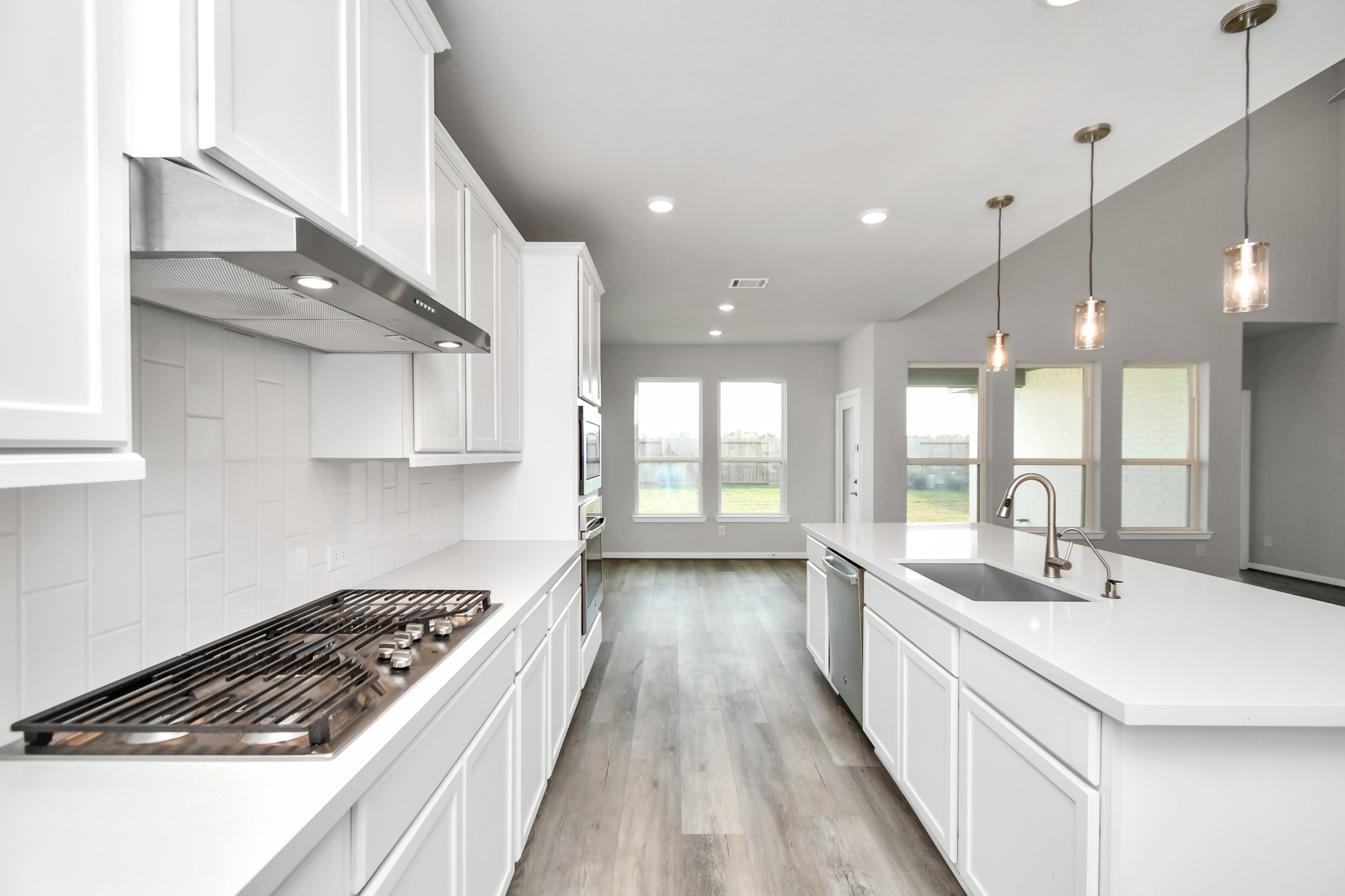 1218 Raburn Run Lane Tomball, TX 77375 - Photo 10 of 37 a kitchen with stainless steel appliances a sink stove and cabinets
