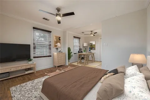 a bedroom with a bed and flat screen tv