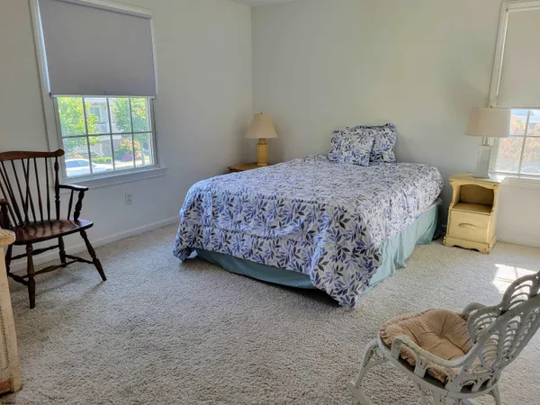 a bedroom with a bed and a chair