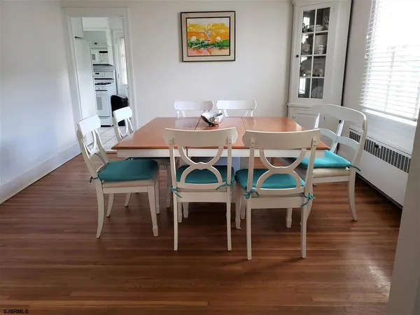 a view of a dining room with furniture and wooden floor