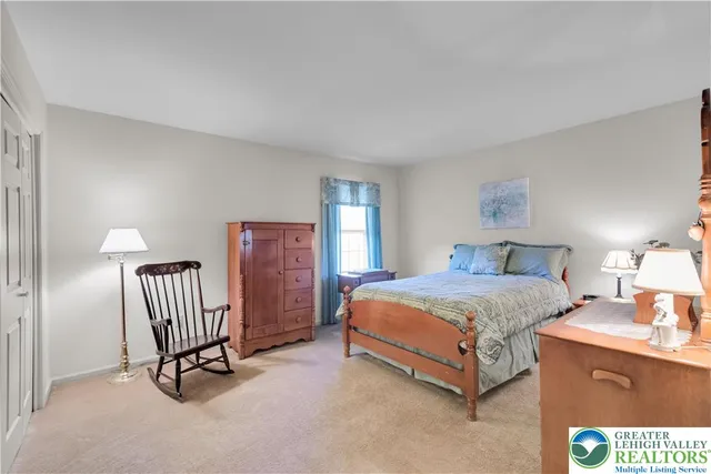 a bedroom with a bed and a chair