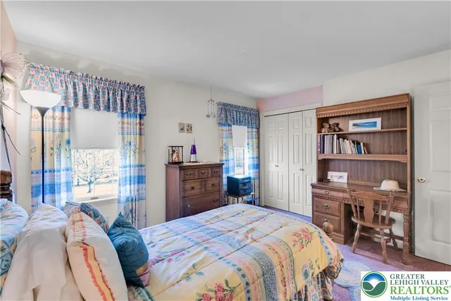 a bedroom with a bed a dresser and a book shelf