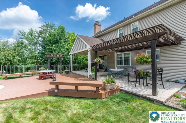 a backyard of a house with table and chairs