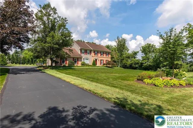 a view of a house with a big yard and potted plants