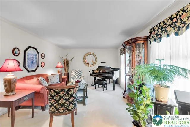 a dining room with furniture and a potted plant