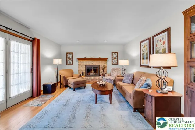 a living room with furniture a window and a fireplace