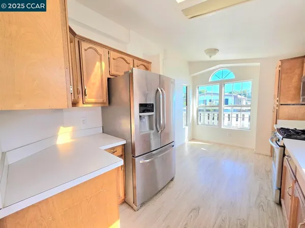 a kitchen with stainless steel appliances a refrigerator and a stove top oven