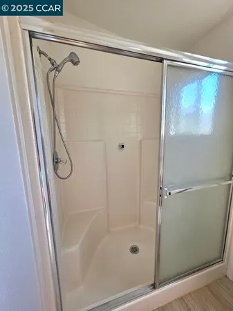 a bathroom with a shower a toilet and sink