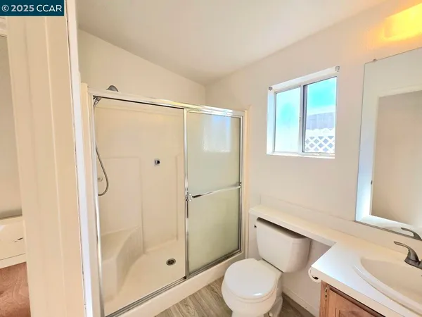 a bathroom with a shower a toilet and sink