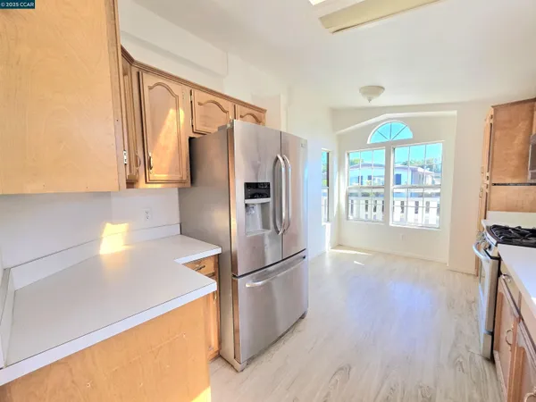a kitchen with stainless steel appliances a refrigerator and a stove top oven