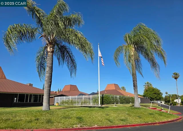 a view of a white house with a yard
