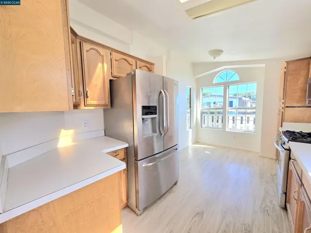a kitchen with stainless steel appliances a refrigerator and a stove top oven