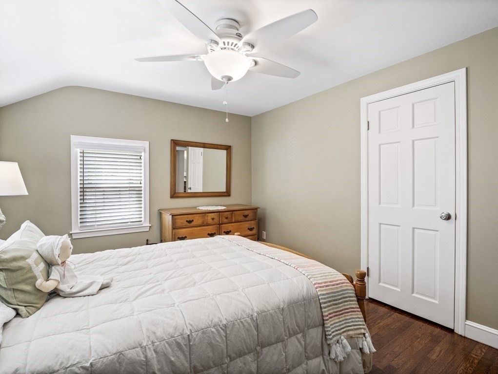 43 Windsor Road Stoneham, MA 02180 - Photo 26 of 42 a bedroom with a large bed and wooden floor
