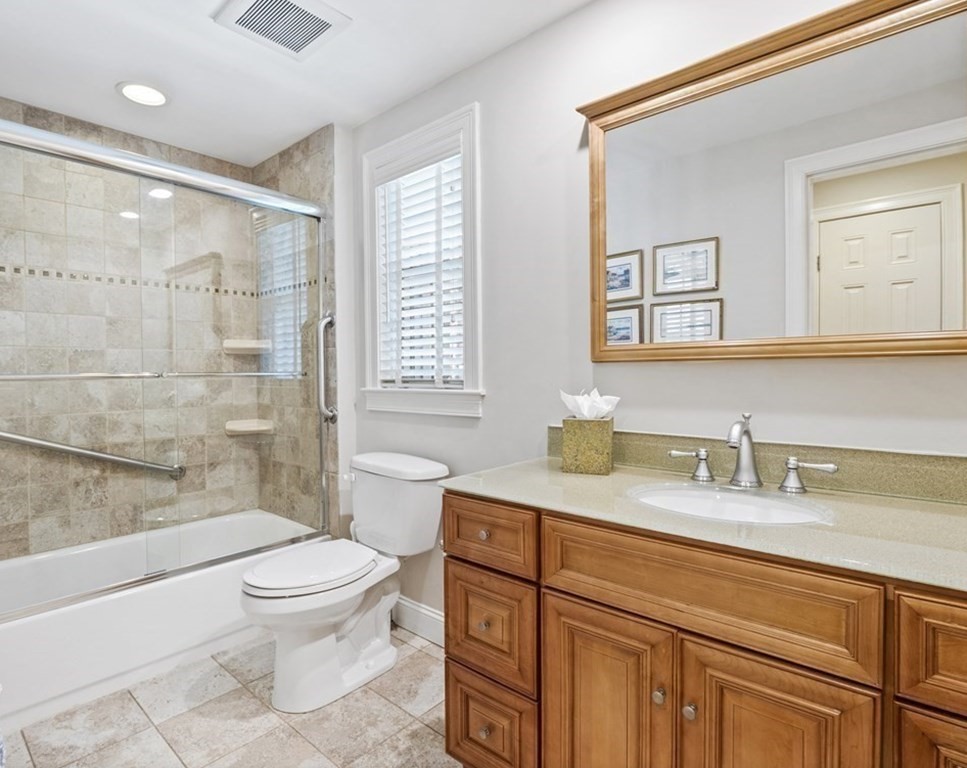43 Windsor Road Stoneham, MA 02180 - Photo 29 of 42 a bathroom with a granite countertop sink toilet a mirror and shower
