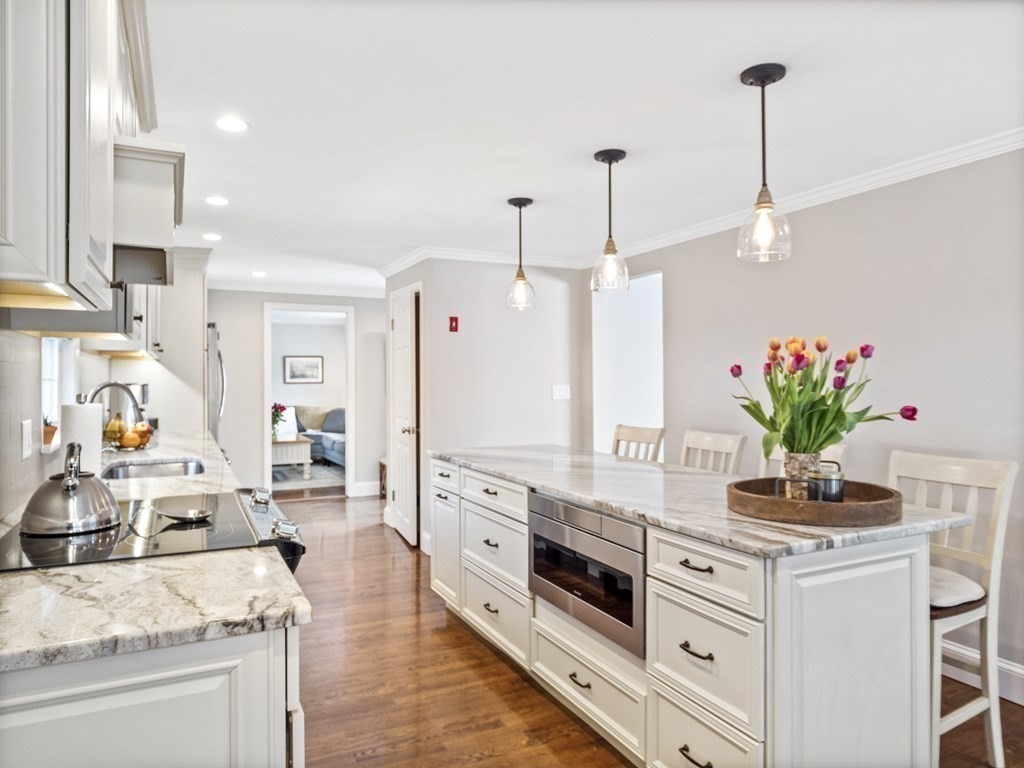 43 Windsor Road Stoneham, MA 02180 - Photo 9 of 42 a kitchen with granite countertop white cabinets and white appliances