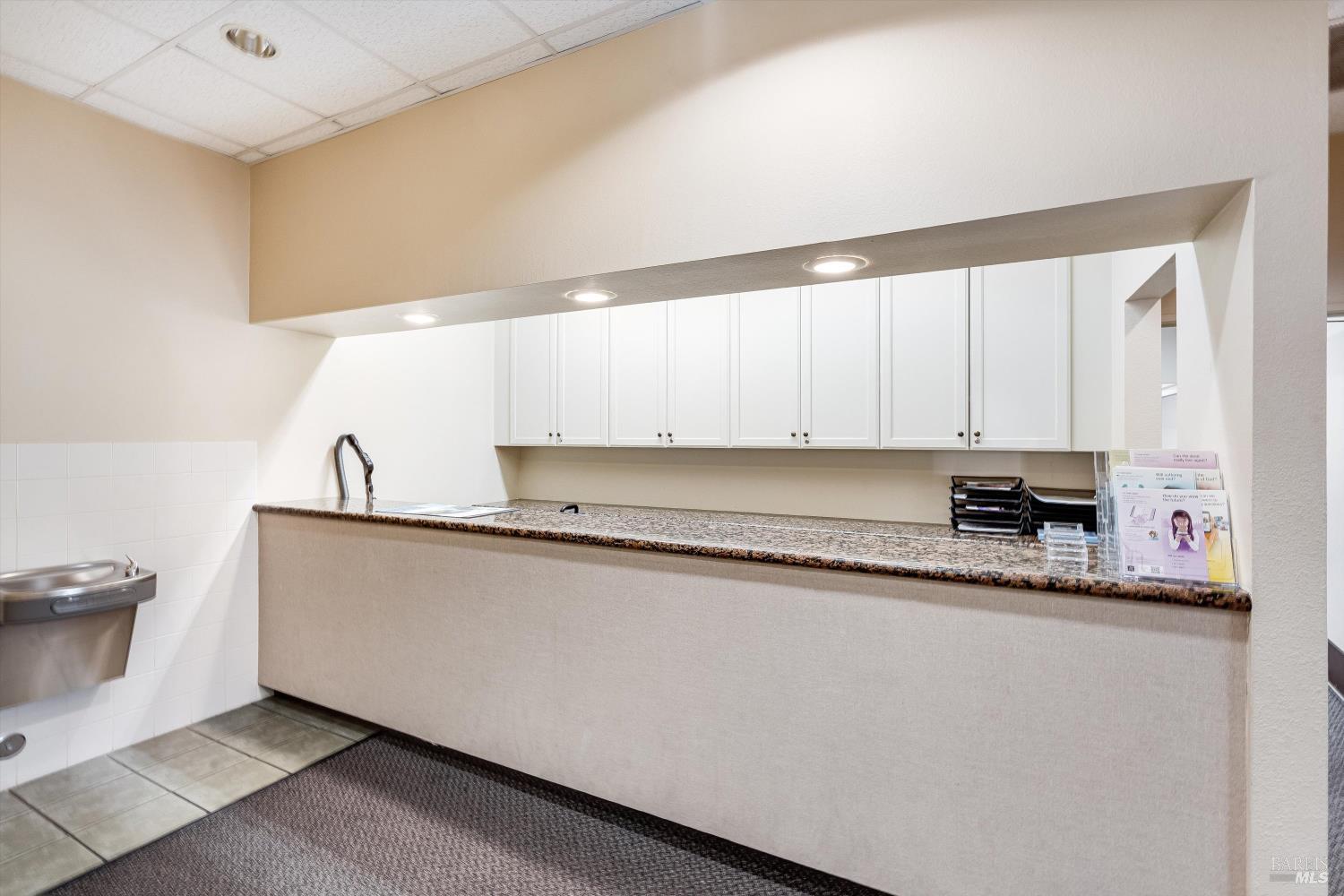 1105 University Avenue Healdsburg, CA 95448 - Photo 12 of 29 a kitchen with granite countertop a sink and a stove