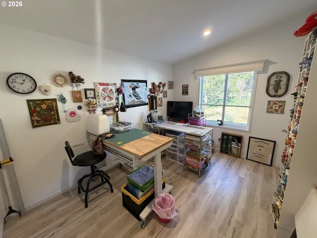 a living room with furniture a flat screen tv and a window