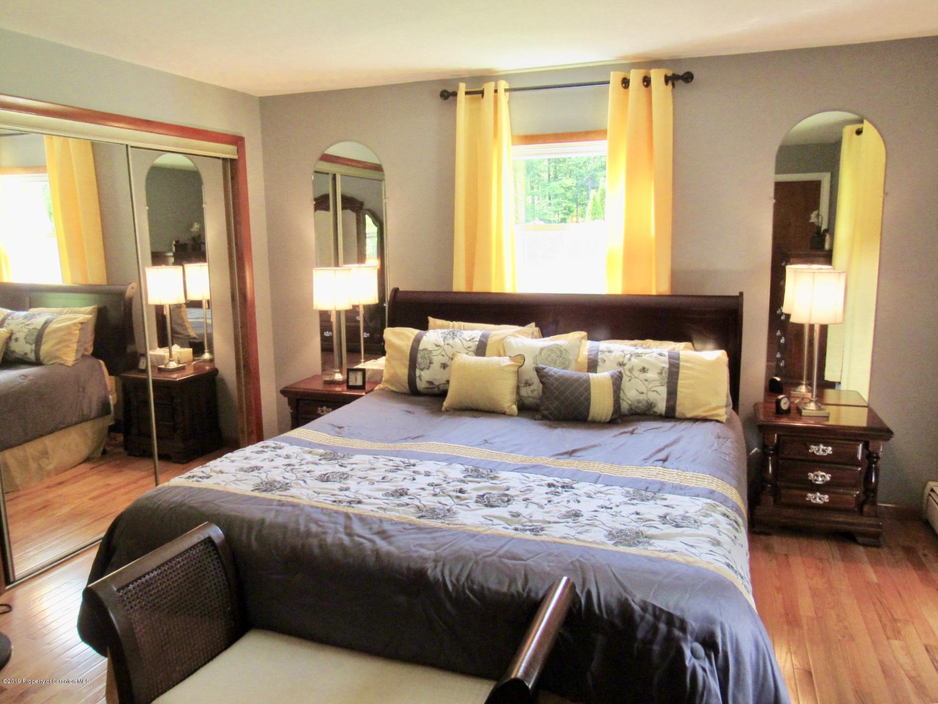 76 Ripplebrook Road Tunkhannock, PA 18657 - Photo 13 of 37 a bedroom with a bed and wooden floor