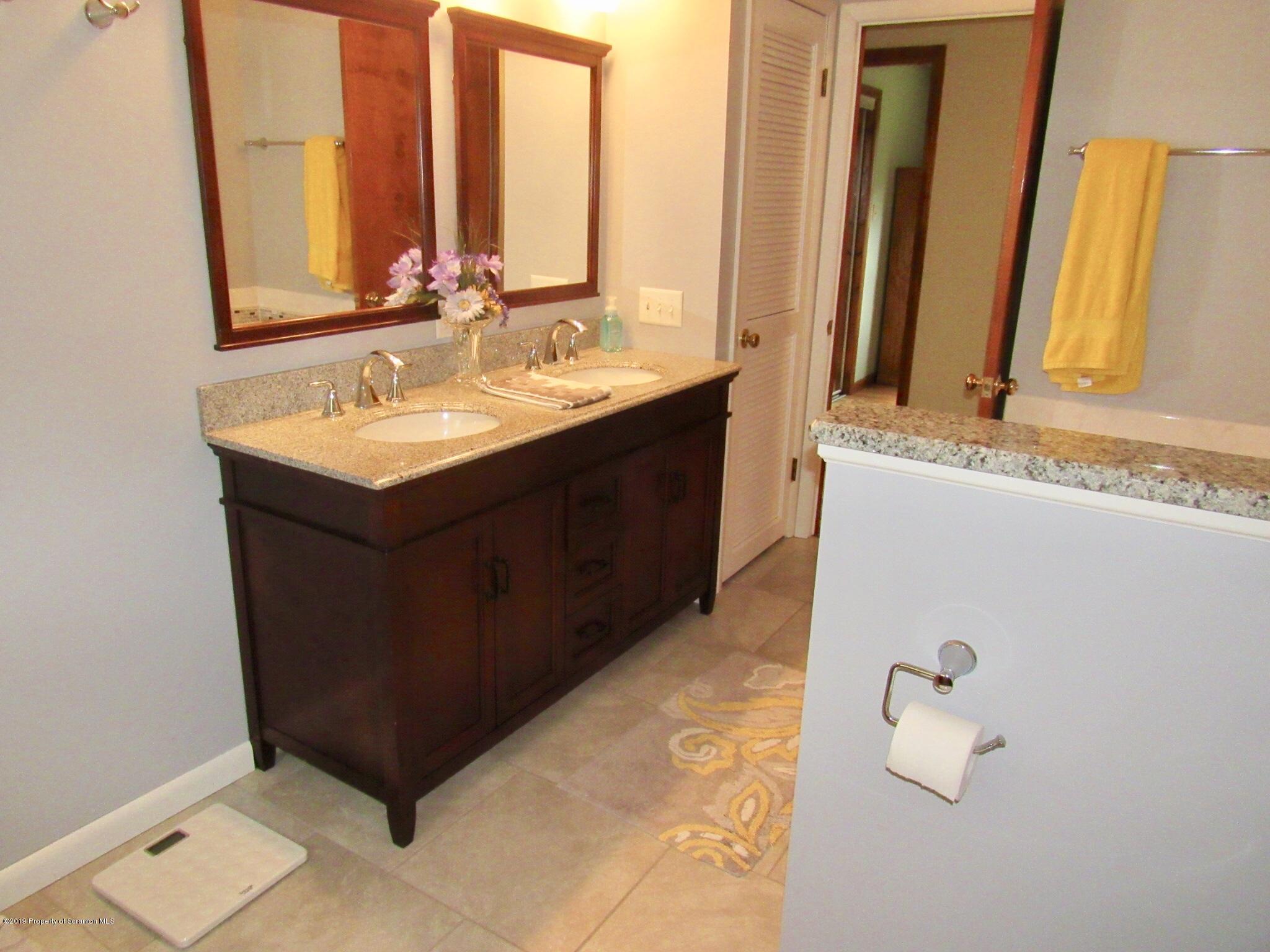76 Ripplebrook Road Tunkhannock, PA 18657 - Photo 21 of 37 a bathroom with a double vanity sink and mirror