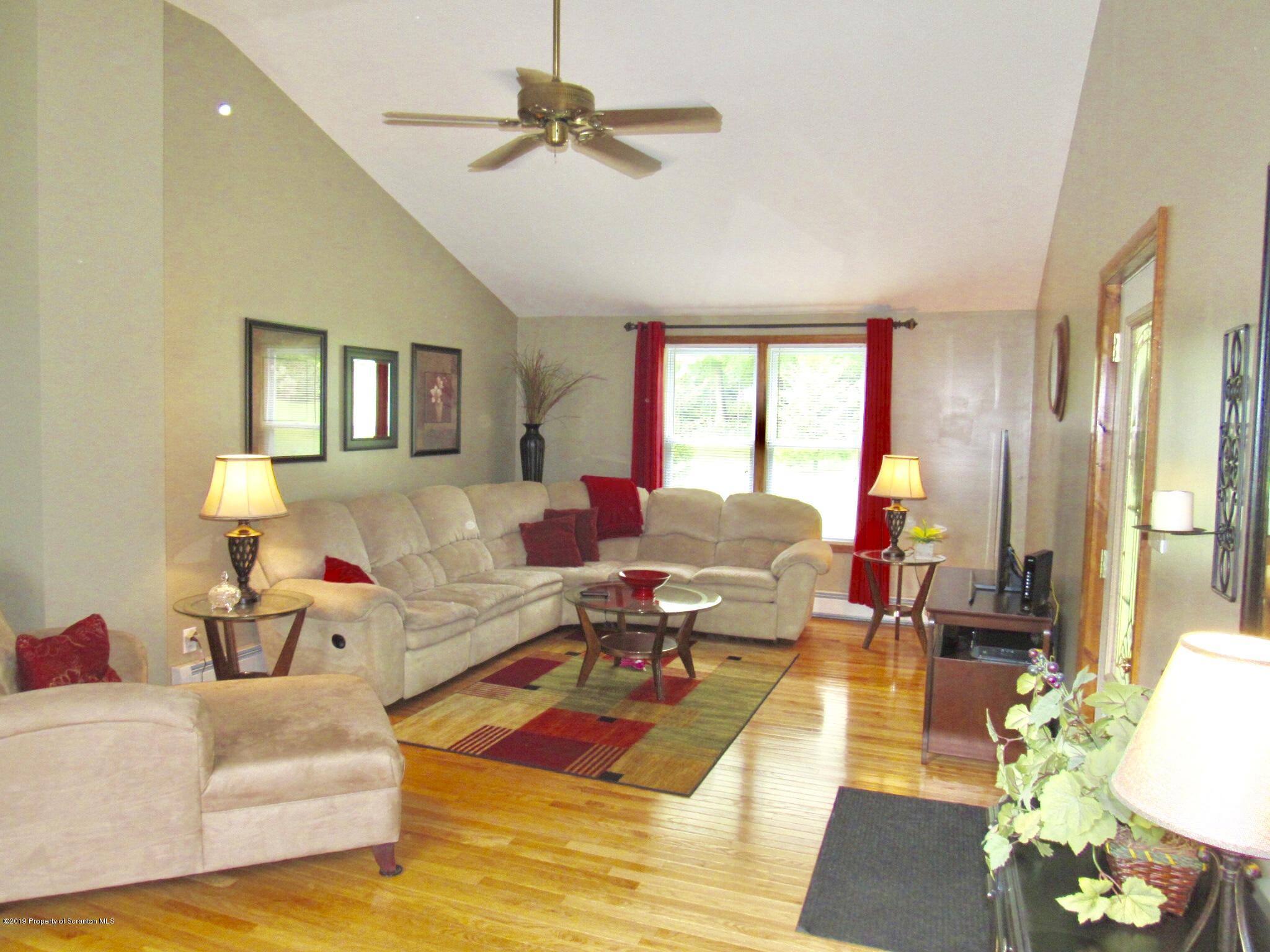 76 Ripplebrook Road Tunkhannock, PA 18657 - Photo 6 of 37 a living room with furniture and a chandelier