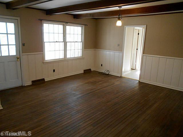 123 Sagewood Road Jamestown, NC 27282 - Photo 6 of 16 Den/Family/Great Room. Exposed beams, hardwood floors, wainscoting, brick fireplace, and screened porch access are just a few of the marvelous features to this spacious den.