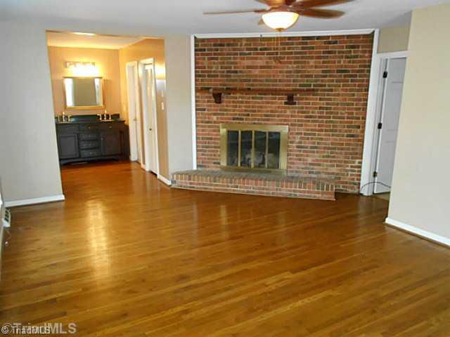 123 Sagewood Road Jamestown, NC 27282 - Photo 8 of 16 Master Bedroom. The master bedroom is on the main floor, has an updated bathroom, and cozy brick fireplace.