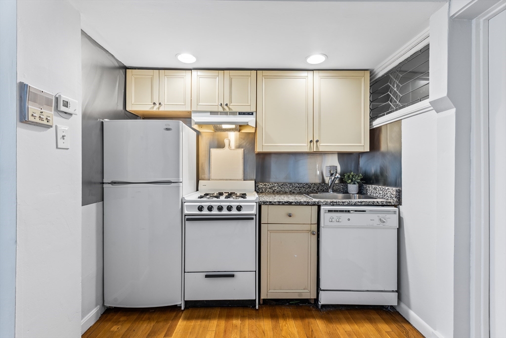 86 Savin Hill Avenue, Unit 1 Boston, MA 02125 - Photo 4 of 17 a kitchen with stainless steel appliances a refrigerator sink and cabinets