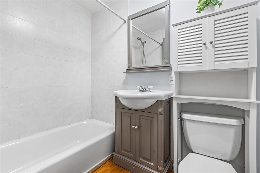 86 Savin Hill Avenue, Unit 1 Boston, MA 02125 - Photo 9 of 17 a bathroom with a sink a toilet and bathtub