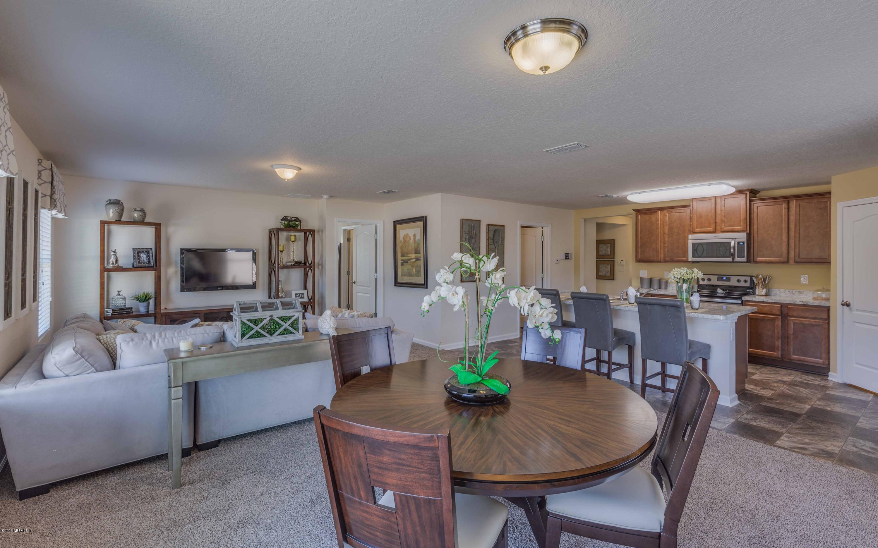 3820 Great Falls Loop Middleburg, FL 32068 - Photo 12 of 36 a living room with furniture and a kitchen view