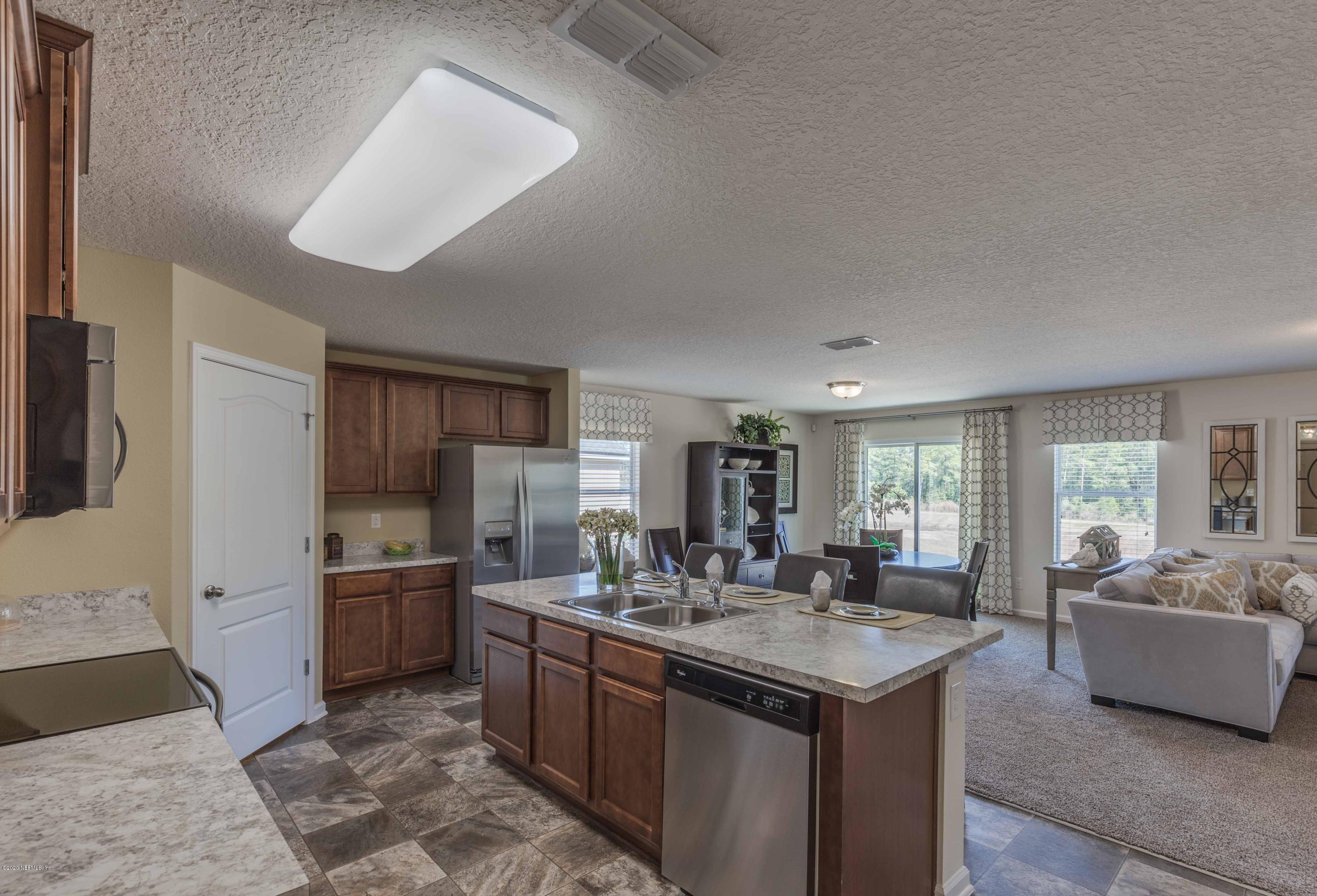 3820 Great Falls Loop Middleburg, FL 32068 - Photo 14 of 36 a kitchen with sink stove and refrigerator