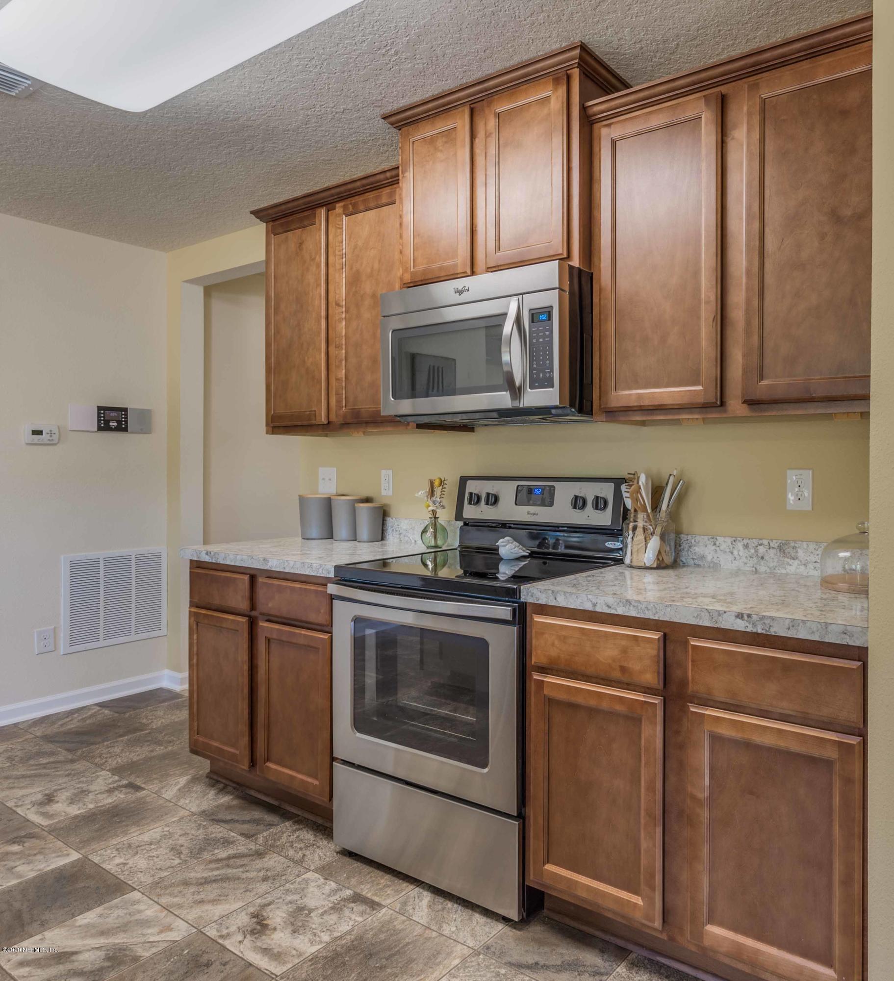3820 Great Falls Loop Middleburg, FL 32068 - Photo 18 of 36 a kitchen with granite countertop a sink and a stove top oven