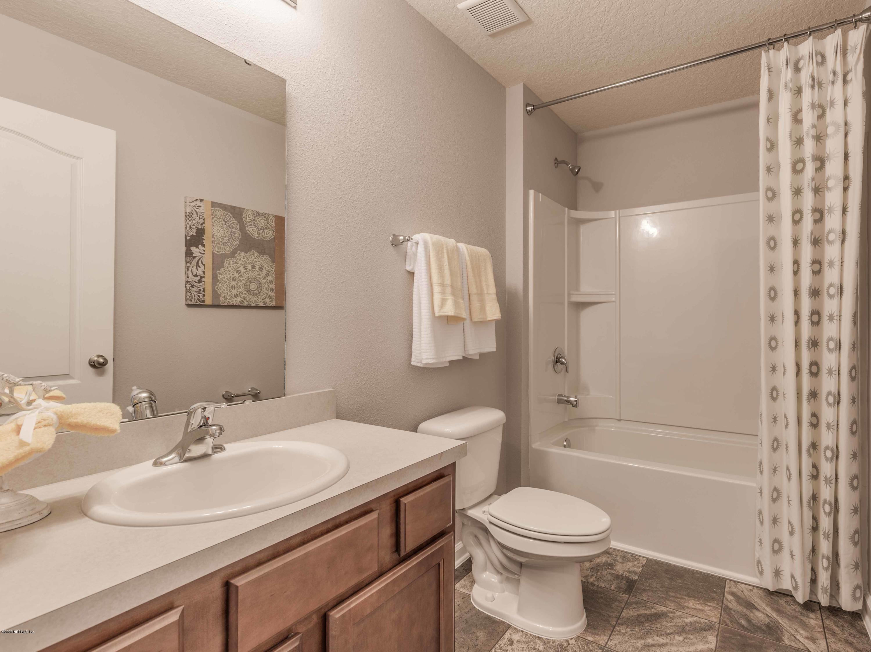 3820 Great Falls Loop Middleburg, FL 32068 - Photo 19 of 36 a bathroom with a sink toilet and shower