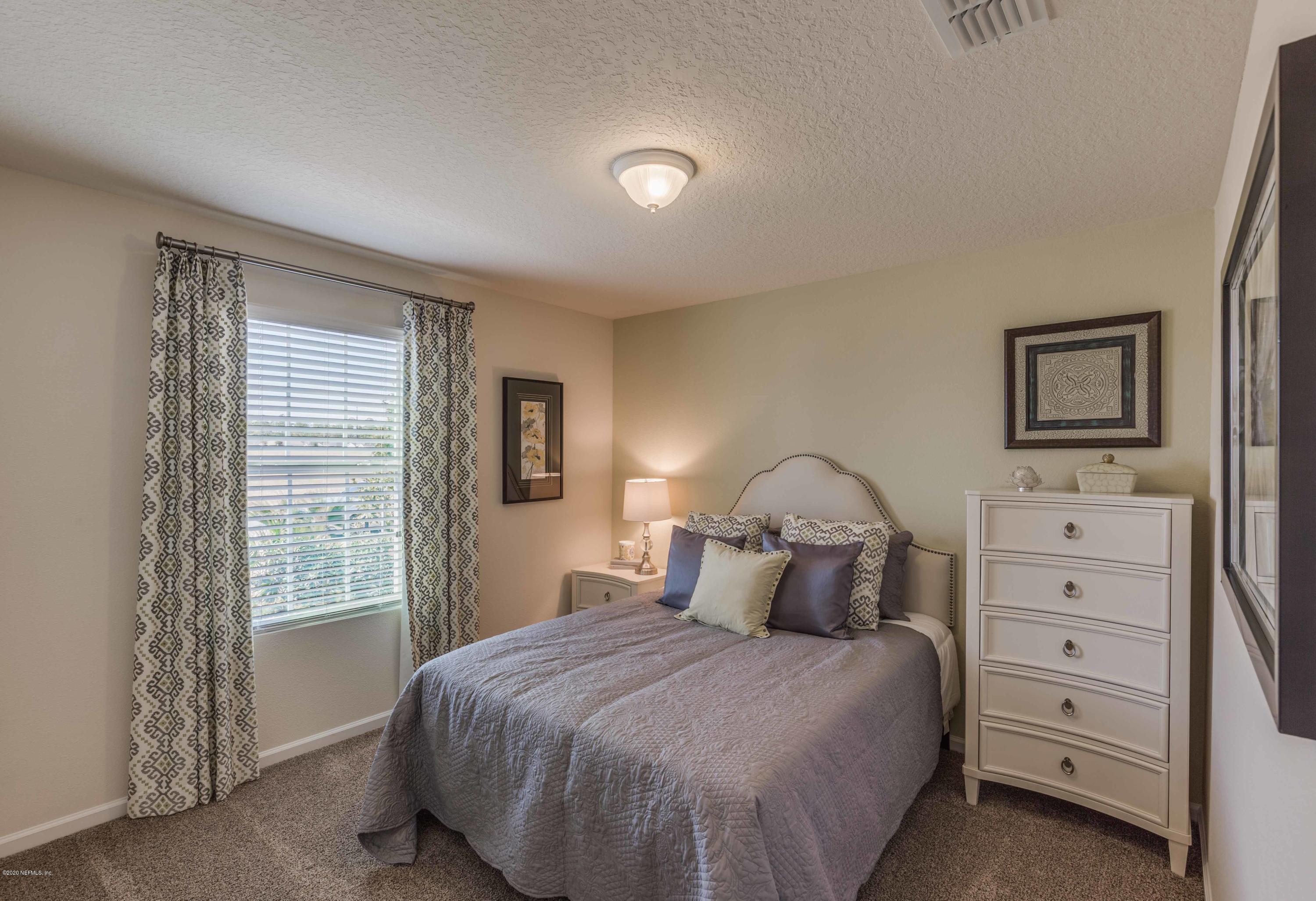 3820 Great Falls Loop Middleburg, FL 32068 - Photo 20 of 36 a bedroom with a bed and a night stand